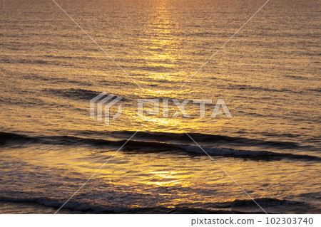 The ocean dyed golden by the reflection of sunrise The ocean dyed golden by the reflection of sunrise 102303740