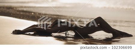 Sexy bikini beach vacation woman laying on the beach in freedom feeling, enjoying her summer vacation 102306699