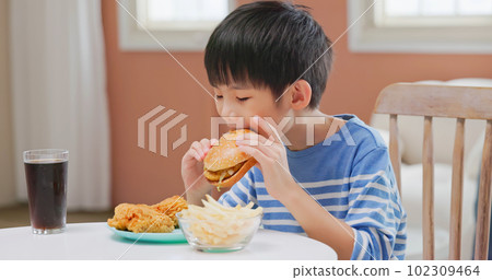 asian boy eat unhealthy food asian boy eat unhealthy food 102309464
