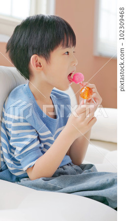 asian boy eat unhealthy food asian boy eat unhealthy food 102309468
