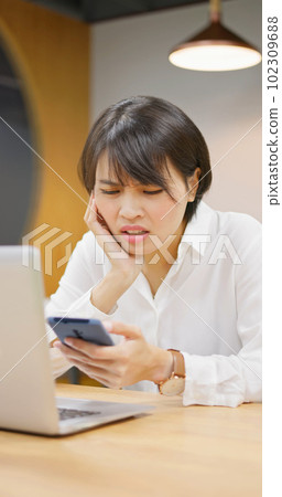 businesswoman looking on mobile 102309688