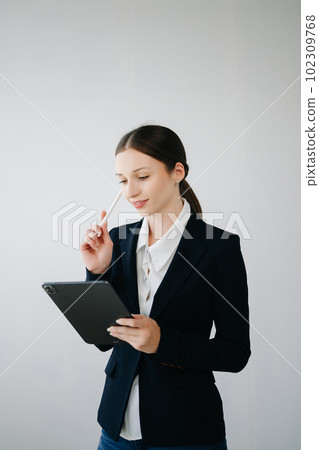 Smiling caucasian young businesswoman bank employee worker manager boss ceo looking at camera, using tablet, laptop and notepad online isolated in white background. 102309768