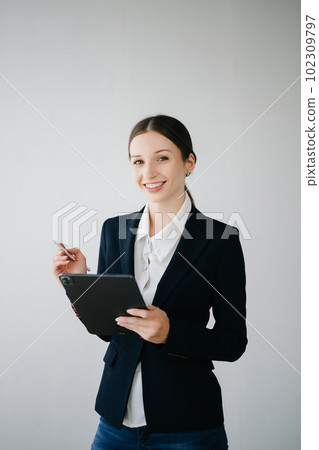 Smiling caucasian young businesswoman bank employee worker manager boss ceo looking at camera, using tablet, laptop and notepad online isolated in white background. Smiling caucasian young businesswoman bank employee worker manager boss ceo looking at camera, using tablet, laptop and notepad online isolated in white background. 102309797