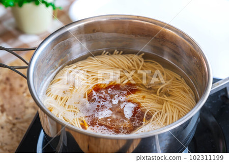 Making ramen, adding liquid soup Making ramen, adding liquid soup 102311199