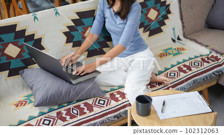 Work from home concept, Business women is typing financial report while working remotely at home Work from home concept, Business women is typing financial report while working remotely at home 102312063