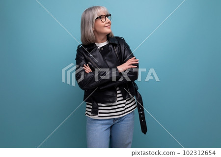 middle age business. 60s mature woman in gray hair looking great in stylish look on blue background 102312654