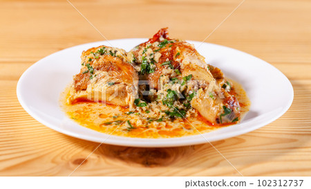 Shkmeruli is a traditional Georgian dish of chicken in garlic sauce in the white plate Shkmeruli is a traditional Georgian dish of chicken in garlic sauce in the white plate 102312737