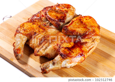 Fried chicken tabaka on a wooden board Fried chicken tabaka on a wooden board 102312746