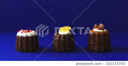 canelé on blue background canelé on blue background 102313350