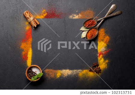 Various spices on stone table 102313731