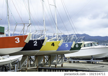 Row of numbered colorful yachts Row of numbered colorful yachts 102314711