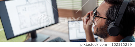 indian male designer in headphones works in home office drawing on graphic tablet indian male designer in headphones works in home office drawing on graphic tablet 102315259