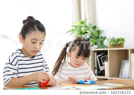Elementary school students playing with origami 102316172