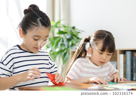 Elementary school students playing with origami 102316174