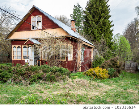 view of cottage in village on overgrown yard 102316634