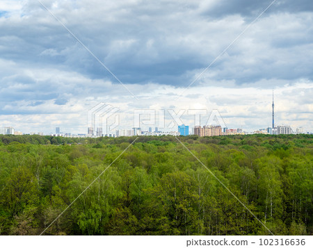 rainy clouds over green forest and city in spring rainy clouds over green forest and city in spring 102316636