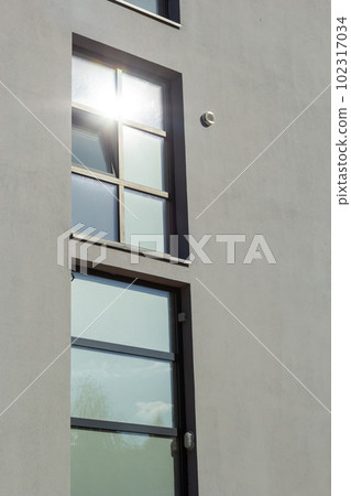 Architectural details of the facade of modern office buildings with many windows and balconies 102317034