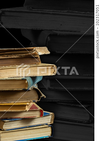 Stack of hardcover old books with on a dark background. Bookshelf shop, Knowledge publications, literature. Bookish bookstore bookstore Stack of hardcover old books with on a dark background. Bookshelf shop, Knowledge publications, literature. Bookish bookstore bookstore 102317051