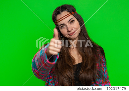 Young woman raises thumbs up agrees or gives positive reply recommends advertisement likes good idea Young woman raises thumbs up agrees or gives positive reply recommends advertisement likes good idea 102317479