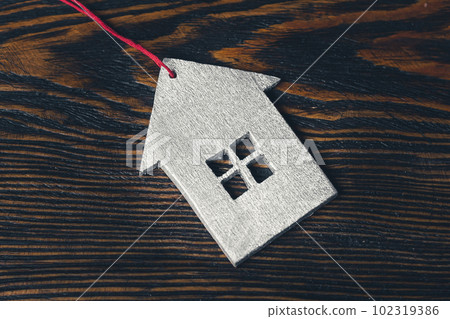 Small wooden house on a wooden table. Small wooden house on a wooden table. 102319386