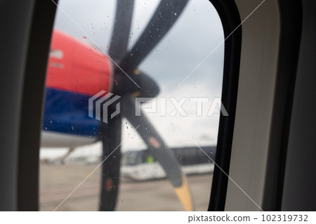 Propeller on the wing of an airplane - view from the window Propeller on the wing of an airplane - view from the window 102319732