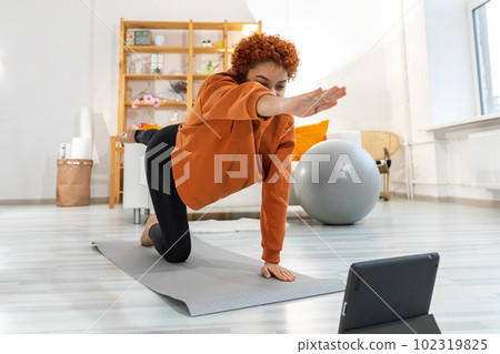 Fitness Workout training. Young healthy fit african girl doing sports exercise on yoga mat on floor at home. Athletic woman in sportswear have training workout for weight loss. Sport and fitness 102319825