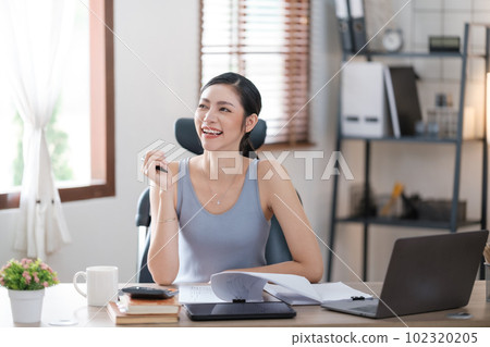 Beautiful Asian young woman wear casual working with social media.Freelance woman working online sale marketing. Shopping online at home. 102320205