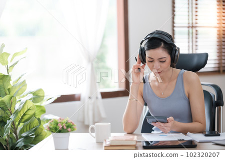 Beautiful Asian young woman wear casual working with social media.Freelance woman working online sale marketing. Shopping online at home. 102320207