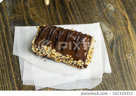 Fresh sweet cake with banana in chocolate glaze and milk filling Fresh sweet cake with banana in chocolate glaze and milk filling 102320353