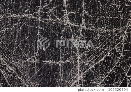 glass broken into a large number of pieces and cracks 102320504