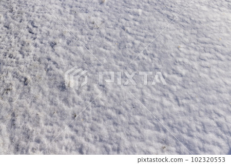 a large amount of snow in snowdrifts in winter 102320553