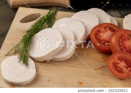 Sliced ripe red tomato on the table 102320621