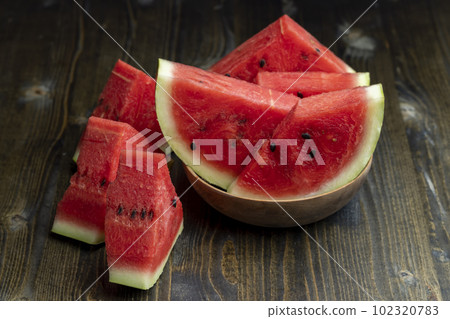Sliced red and ripe watermelon on the table Sliced red and ripe watermelon on the table 102320783