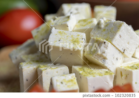 sliced white cottage cheese with spices 102320835