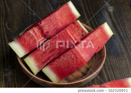 Sliced red and ripe watermelon on the table Sliced red and ripe watermelon on the table 102320951