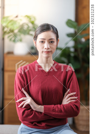 Young beautiful asian girl with beautiful smile wearing casual red t-shirt in the living room, smiling and happy. Young beautiful asian girl with beautiful smile wearing casual red t-shirt in the living room, smiling and happy. 102321238