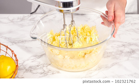Step by step. Mixing ingredients in a glass mixing bowl to prepare lemon bundt cake. Step by step. Mixing ingredients in a glass mixing bowl to prepare lemon bundt cake. 102321762