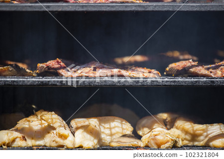 Cabinet for smoking fish. Fresh fish is laid out on the shelves, the process of smoking sea fish. Cabinet for smoking fish. Fresh fish is laid out on the shelves, the process of smoking sea fish. 102321804