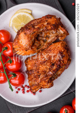 Delicious fried sea bass fish in the form of slices with spices and herbs 102322029