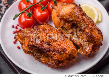 Delicious fried sea bass fish in the form of slices with spices and herbs 102322030