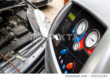 refueling climate system of old car in repair shop refueling climate system of old car in repair shop 102322163