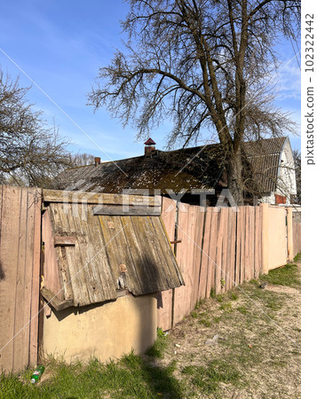 wooden old painted fence near the house in the village wooden old painted fence near the house in the village 102322442