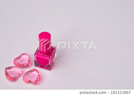 Pink nail polish with glass hearts of pink color Pink nail polish with glass hearts of pink color 102323907
