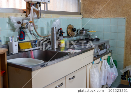 The kitchen of an old rental house that has been built for many years The kitchen of an old rental house that has been built for many years 102325261
