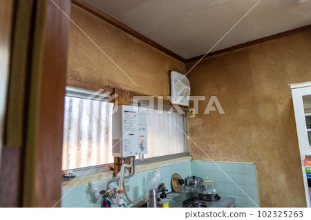 The kitchen of an old rental house that has been built for many years The kitchen of an old rental house that has been built for many years 102325263