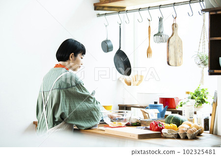 Young woman making pumpkin pancakes Young woman making pumpkin pancakes 102325481