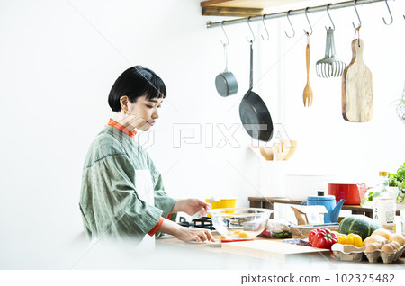 Young woman making pumpkin pancakes Young woman making pumpkin pancakes 102325482