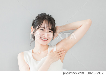 Smiling Asian woman with depilation and deodorant image 102325917
