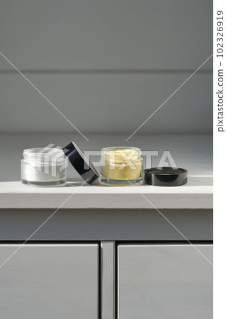 A jar of rice flour face scrub and a jar of turmeric face scrub. 102326919