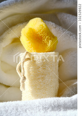 Loofah washcloth and organic sea sponge on the background of towel. Loofah washcloth and organic sea sponge on the background of towel. 102326922